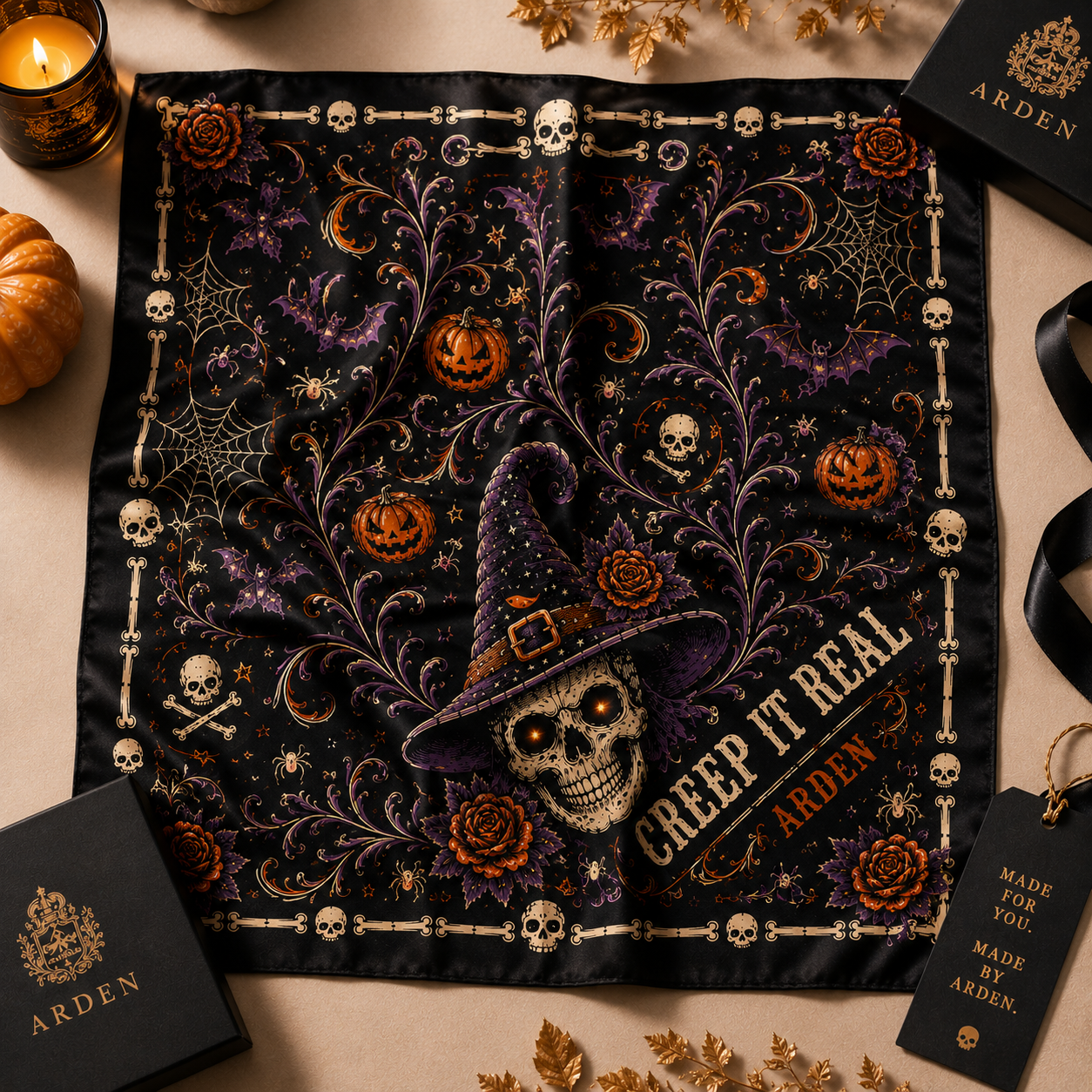 Halloween corporate gift bandana with a skull and pumpkin design, displayed on a table with candles and gift boxes